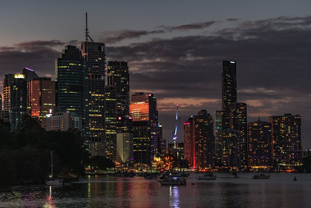 Captivating view of Brisbane's skyline at sunset, reflecting city lights on the river.